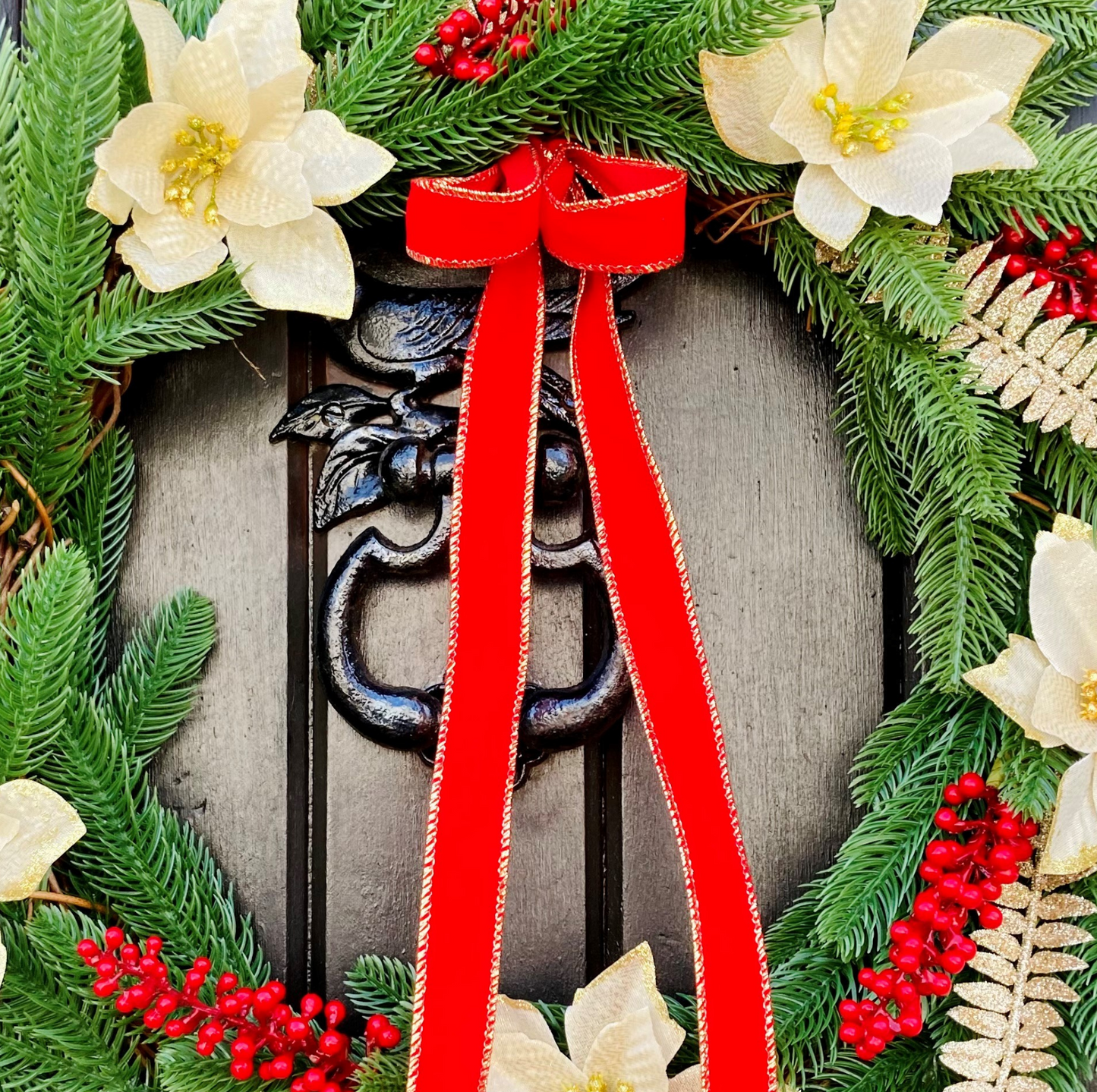 Christmas Wreath With Cream and Gold Poinsettias with Red Berries Presented On A Faux Pine Base