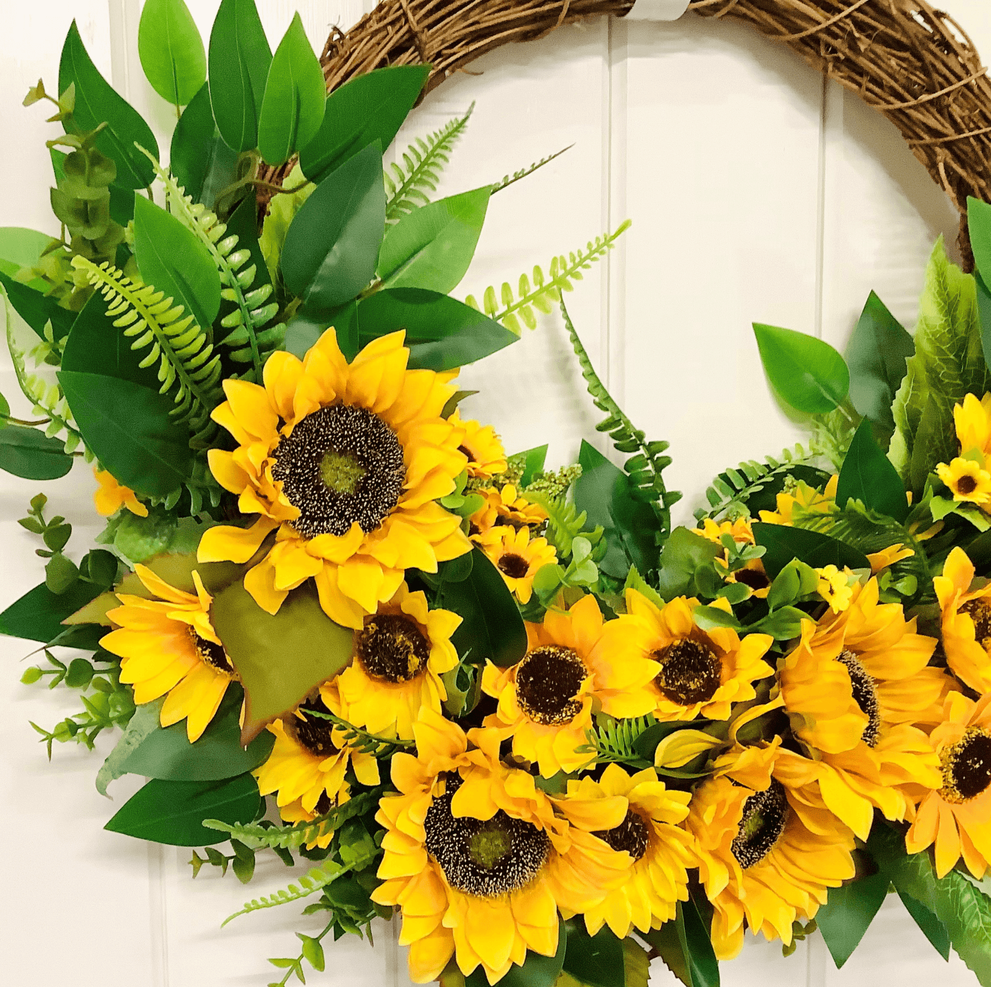 various sizes of bright yellow sunflower half style door wreath