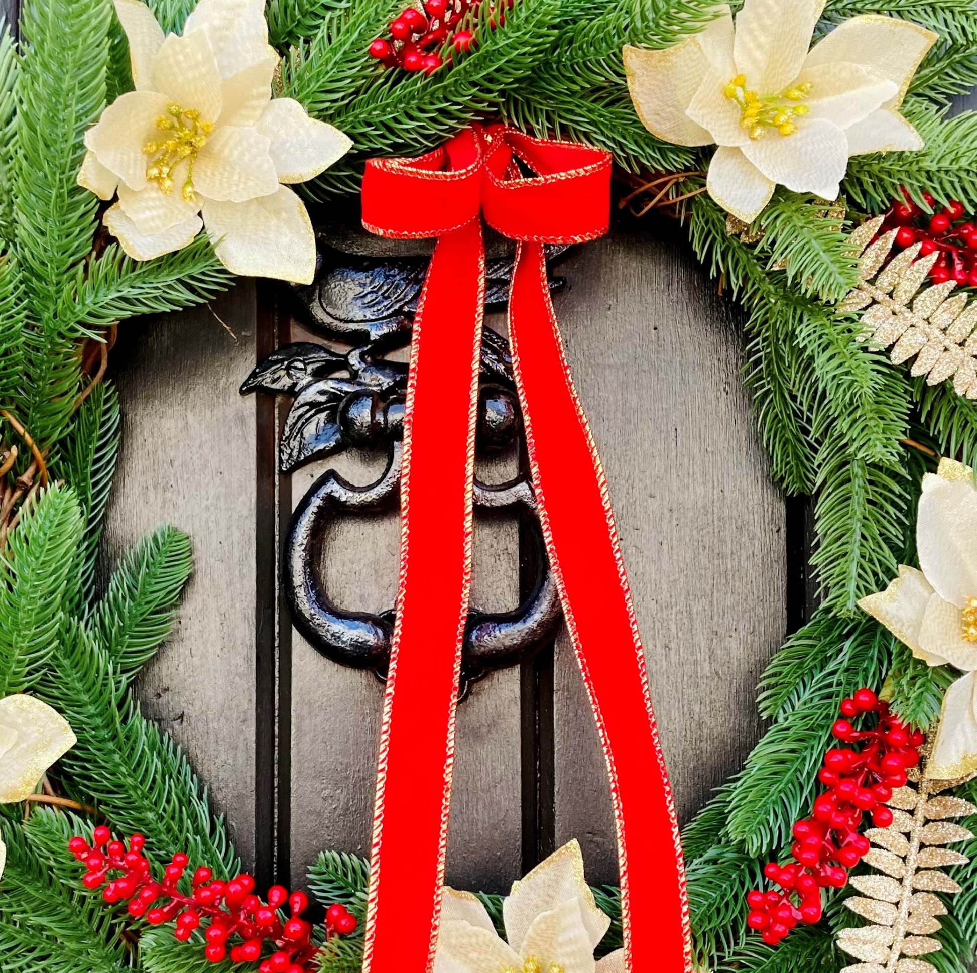 Christmas Wreath With Cream and Gold Poinsettias with Red Berries Presented On A Faux Pine Base