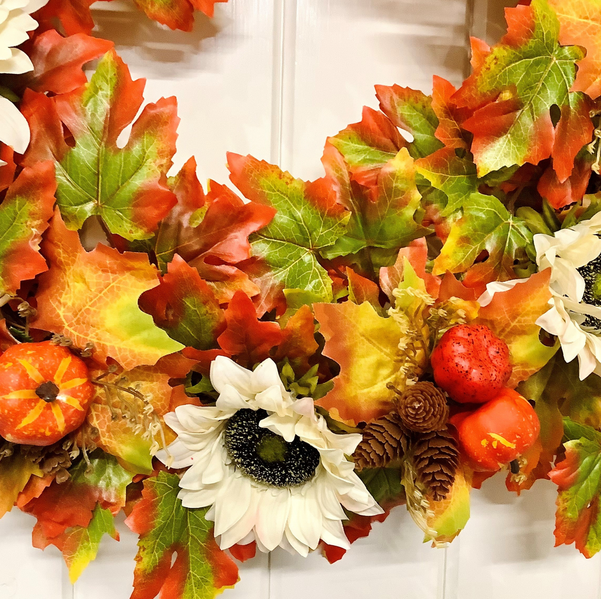 Cream Sunflowers with Pine Cones & Pumpkins set on Autumnal Coloured Crisp Red and Green Maple Leaves on a Grapevine Welcome Door Wreath