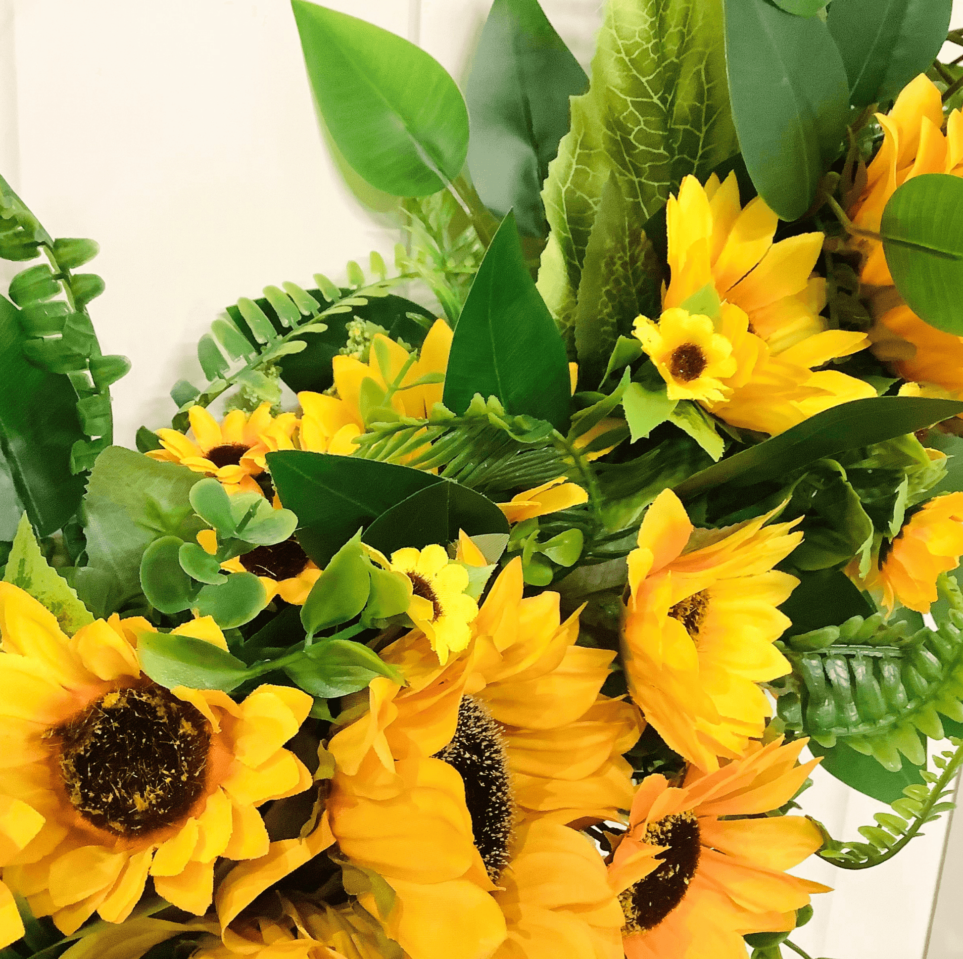 various sizes of bright yellow sunflower half style door wreath