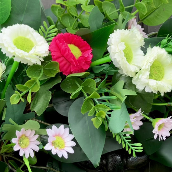 spring summer welcome door wreath with pink and white bellis daisies and greenery