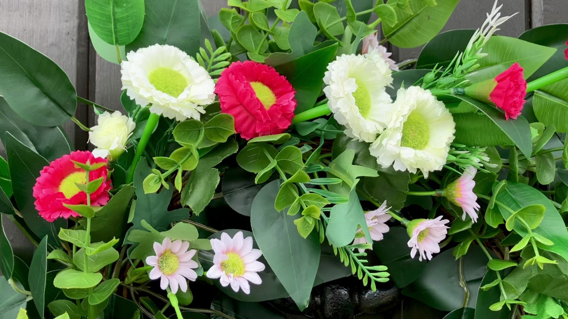 spring summer welcome door wreath with pink and white bellis daisies and greenery